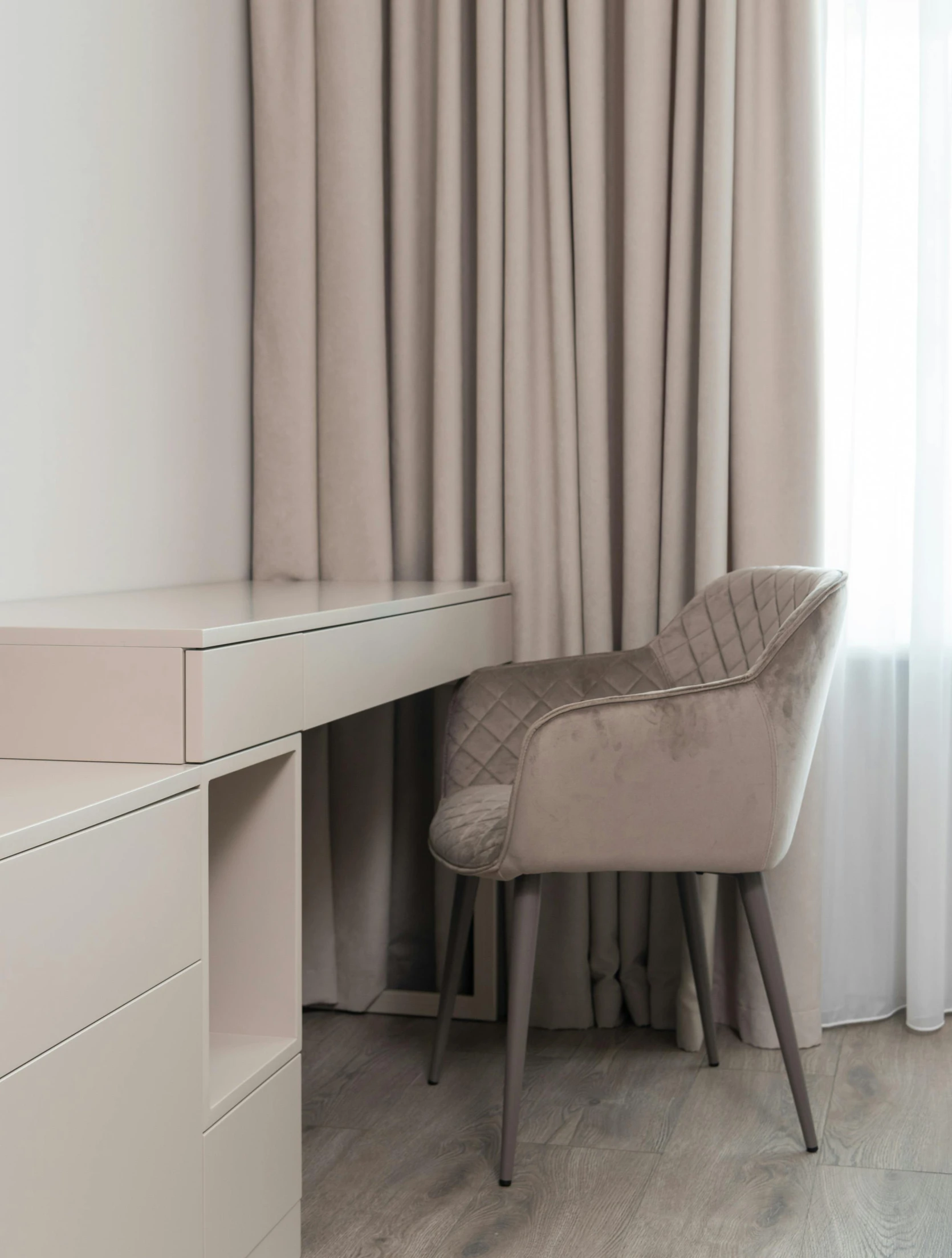 a chair sitting in front of a desk next to a window, drapery, soft colours scheme, taupe, clean and pristine design