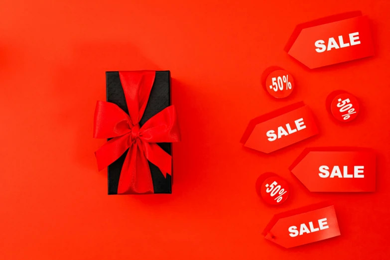 a black gift box with red ribbon and sale tags on a red background, by Julia Pishtar, pexels contest winner, clemens ascher, 🎀 🗡 🍓 🧚, poster template on canva, opening shot