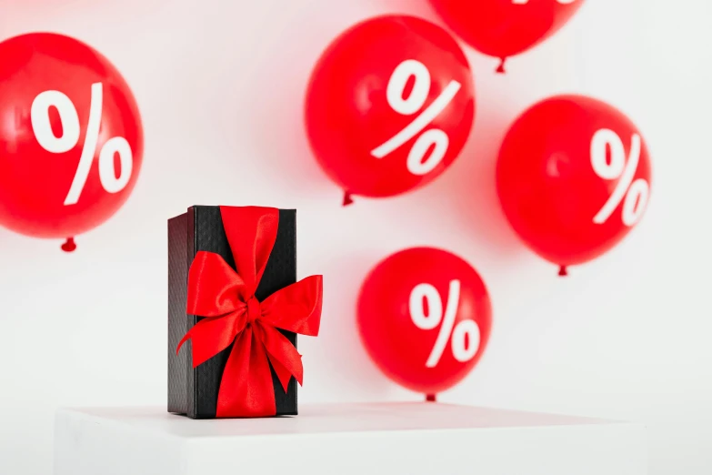 a black box with a red bow and some red balloons, trending on unsplash, letterism, product display photograph, arper's bazaar, proportions off, ornamental bow