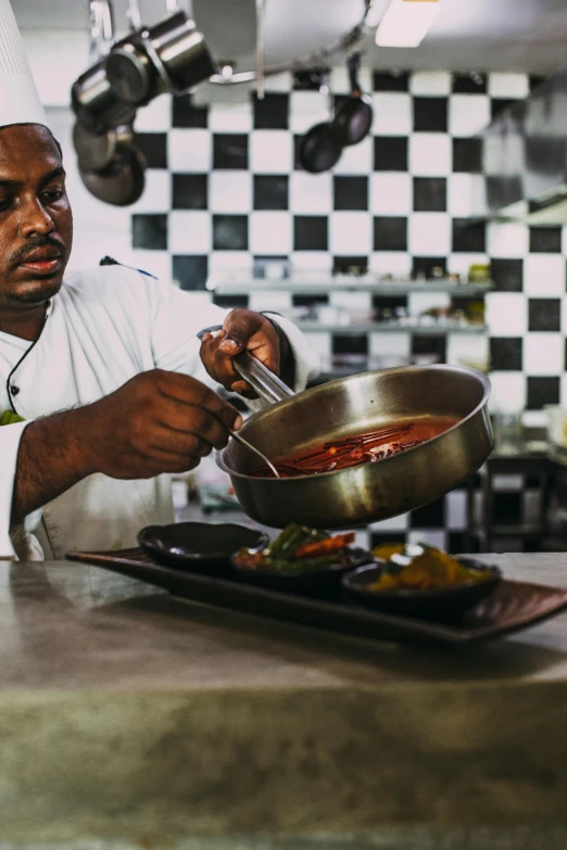 a man in a chef's hat preparing food in a kitchen, inspired by Theo Constanté, ethiopian, soup, award-winning, thumbnail