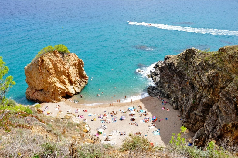 a group of people laying on top of a sandy beach, steep cliffs, rosalia vila i tobella, flatlay, featured