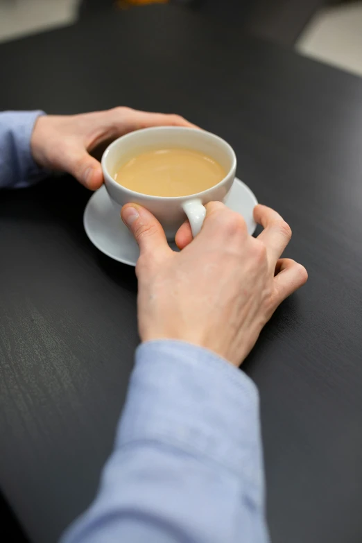 a person holding a cup of coffee on a table, comforting, no text, ultra-detailed, ignant