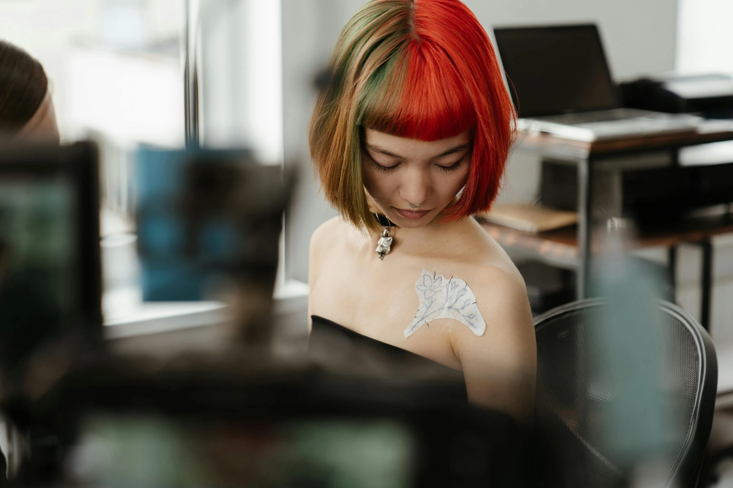 a woman with red hair sitting in a chair, a tattoo, trending on pexels, scifi nanowires on skin, with a bob cut, colourised, shot on canon eos r5