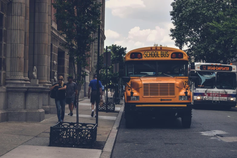 a yellow school bus parked on the side of a street, a photo, pexels contest winner, american barbizon school, people walking around, 🚿🗝📝