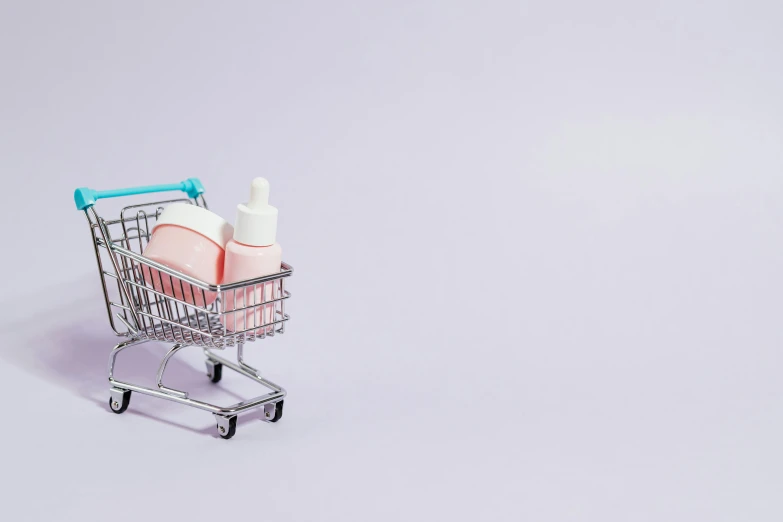 a shopping cart with a bottle of lotion in it, pexels, aestheticism, background image, purple liquid, group photo, profile image