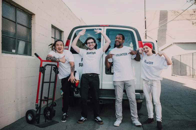 a group of people standing in front of a van, pexels contest winner, justin roiland, clean image, avan jogia angel, supportive