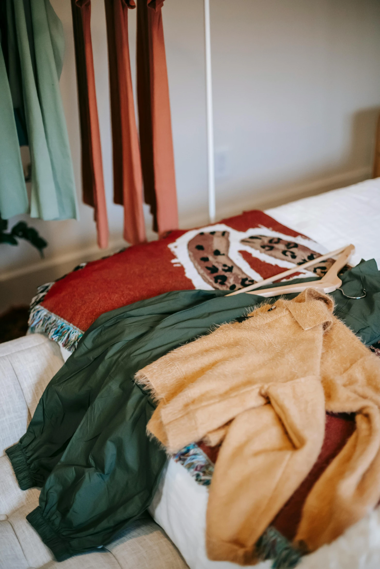 a pile of clothes sitting on top of a bed, green and brown clothes, manuka, holiday vibe, katey truhn