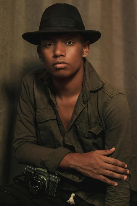 a close up of a person wearing a hat, an album cover, inspired by Byron Galvez, androgynous, studio!! portrait lighting, black teenage boy, portrait full body