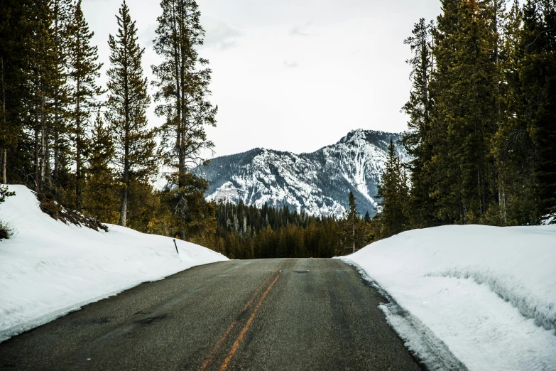 a snowy road with a mountain in the background, pexels contest winner, montana, thumbnail, high resolution image, steep