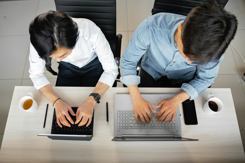 a couple of people sitting at a table with laptops, a computer rendering, trending on unsplash, bend over posture, high angle shot, standing straight, avatar image