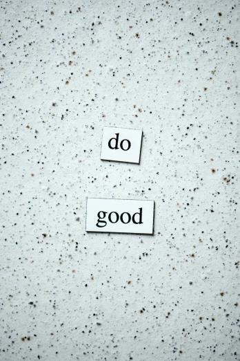 a close up of a piece of paper with words on it, the good, dos, background image, grey