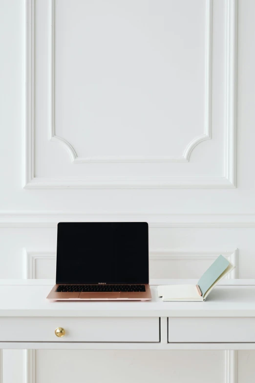 a laptop computer sitting on top of a white desk, by Nicolette Macnamara, dwell, multiple stories, productphoto, elegant study