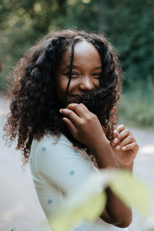 a woman with curly hair posing for a picture, pexels contest winner, black teenage girl, flat ironed hair, portrait featured on unsplash, little shy smile