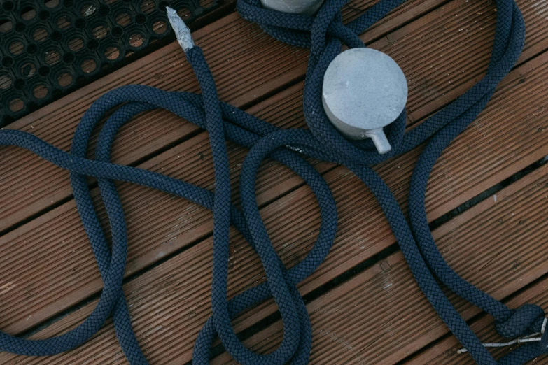 a dog leash sitting on top of a wooden floor, by Adam Marczyński, unsplash, photorealism, on the deck of a ship, blue and grey, tactile buttons and lights, detailed product image
