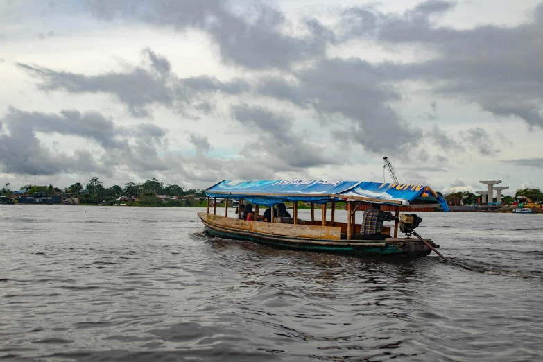 a boat on a body of water under a cloudy sky, hurufiyya, nile river environment, vibrant but dreary, thumbnail, viral post