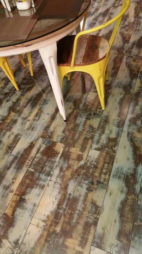 a table and chairs in a room with wood flooring, fallout style istanbul, multi - coloured, acid wash layering, high angle close up shot
