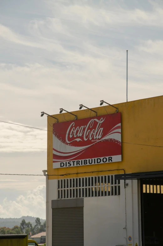 a coca cola sign on the side of a building, by Caro Niederer, trading depots, juan sanchez cotan, sky line, 8 k )