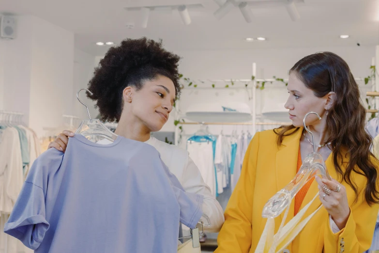 two women standing next to each other in a clothing store, trending on pexels, renaissance, calmly conversing 8k, thumbnail, bright colour, slight overcast