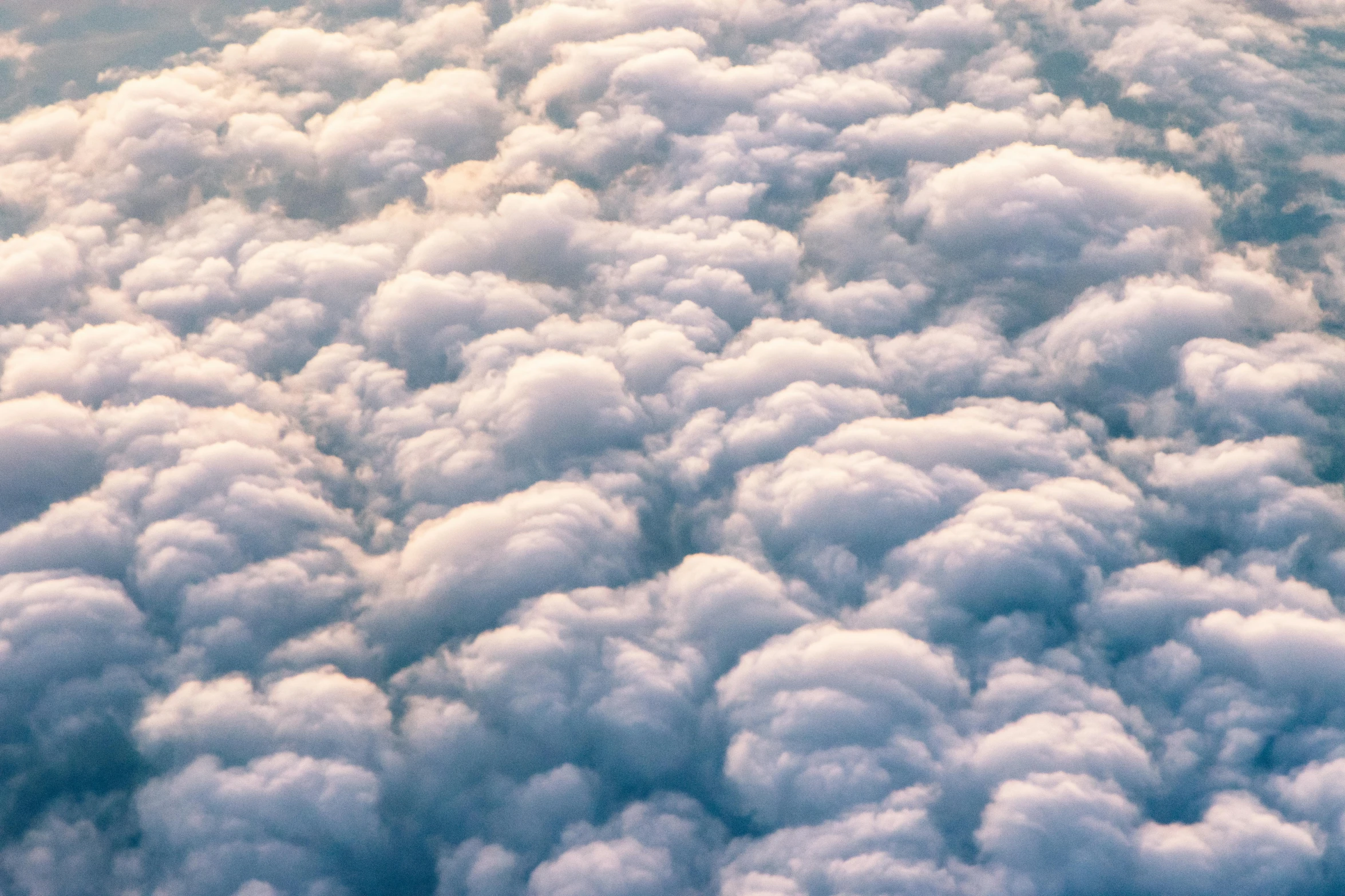 a plane is flying high above the clouds, an album cover, by Niko Henrichon, trending on unsplash, surrealism, cotton candy clouds, layered stratocumulus clouds, high angle close up shot, mammatus clouds