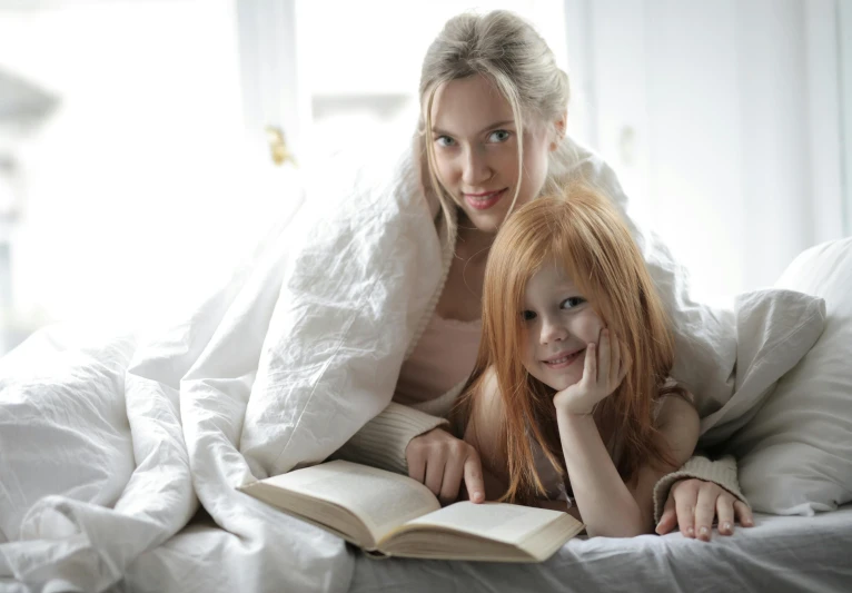 a mother and daughter reading a book on a bed, a portrait, pexels contest winner, figuration libre, ( redhead, grey, thumbnail, a blond