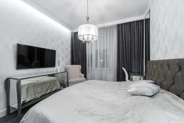 a bed room with a neatly made bed and a flat screen tv, by Adam Marczyński, pexels contest winner, silver，ivory, royal interior, glossy white metal, delicate patterned