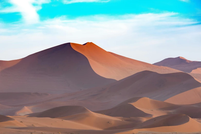 a desert with sand dunes and mountains in the background, pexels contest winner, mauve and cinnabar and cyan, instagram post, dune, light tan
