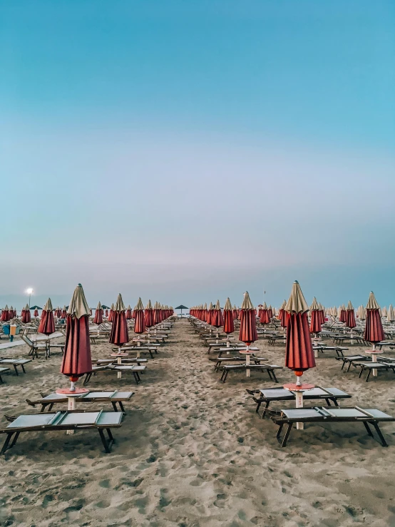 a beach filled with lots of tables and umbrellas, an album cover, by Giorgio De Vincenzi, unsplash contest winner, at twilight, square, striped, italian