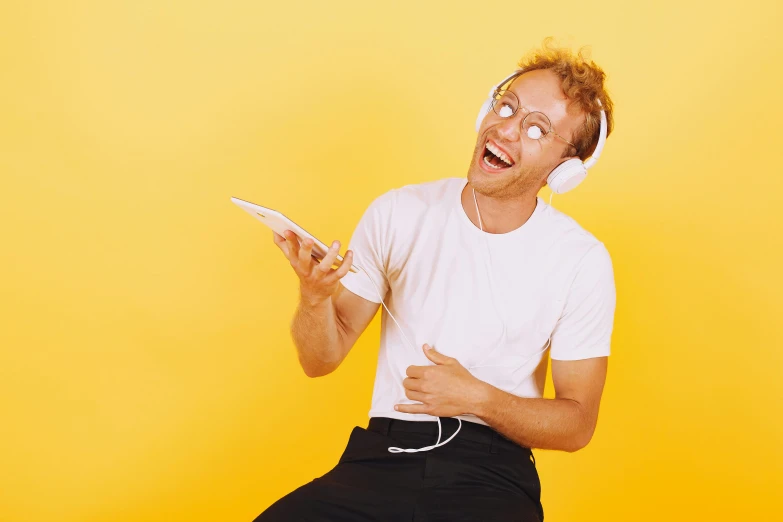 a man sitting on a stool with headphones on, trending on pexels, playful and cheerful, very nerdy, frank bairstow, avatar image