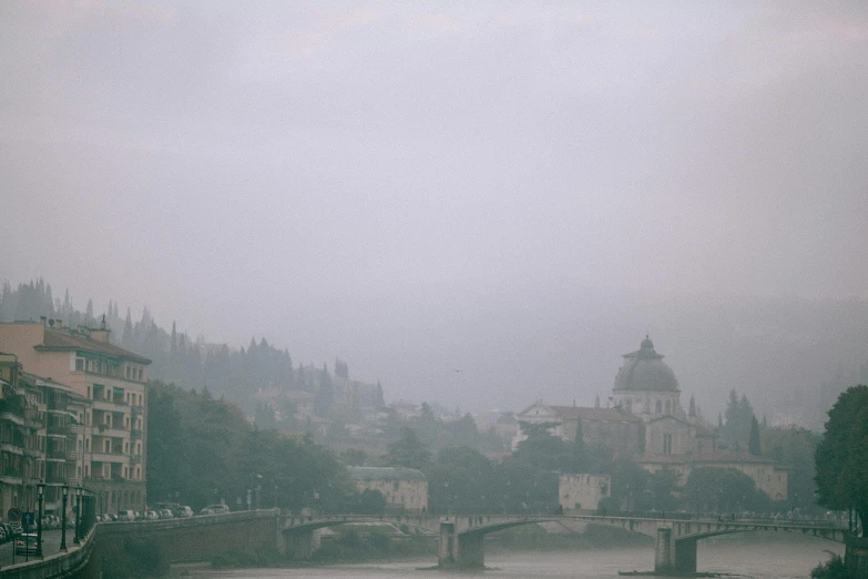 a large body of water with a bridge over it, a picture, by Attila Meszlenyi, unsplash contest winner, renaissance, ground haze, eternal city, shot on hasselblad, view from a distance