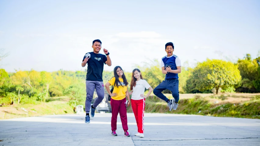 a group of people jumping in the air, a picture, inspired by Baiōken Eishun, pexels contest winner, philippines, avatar image, teenage, mid shot portrait