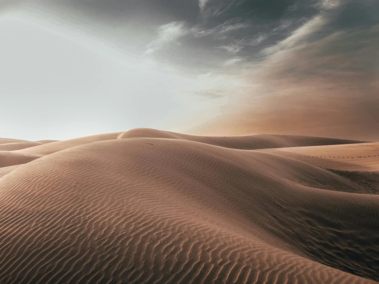 a person standing on top of a sand dune, realism | beeple, unsplash 4k, multiple stories, in the desert beside the gulf