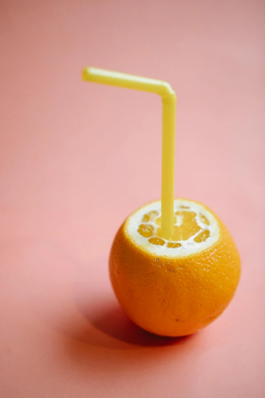 an orange with a straw sticking out of it, epicurious, 2040, lemonade, promo image