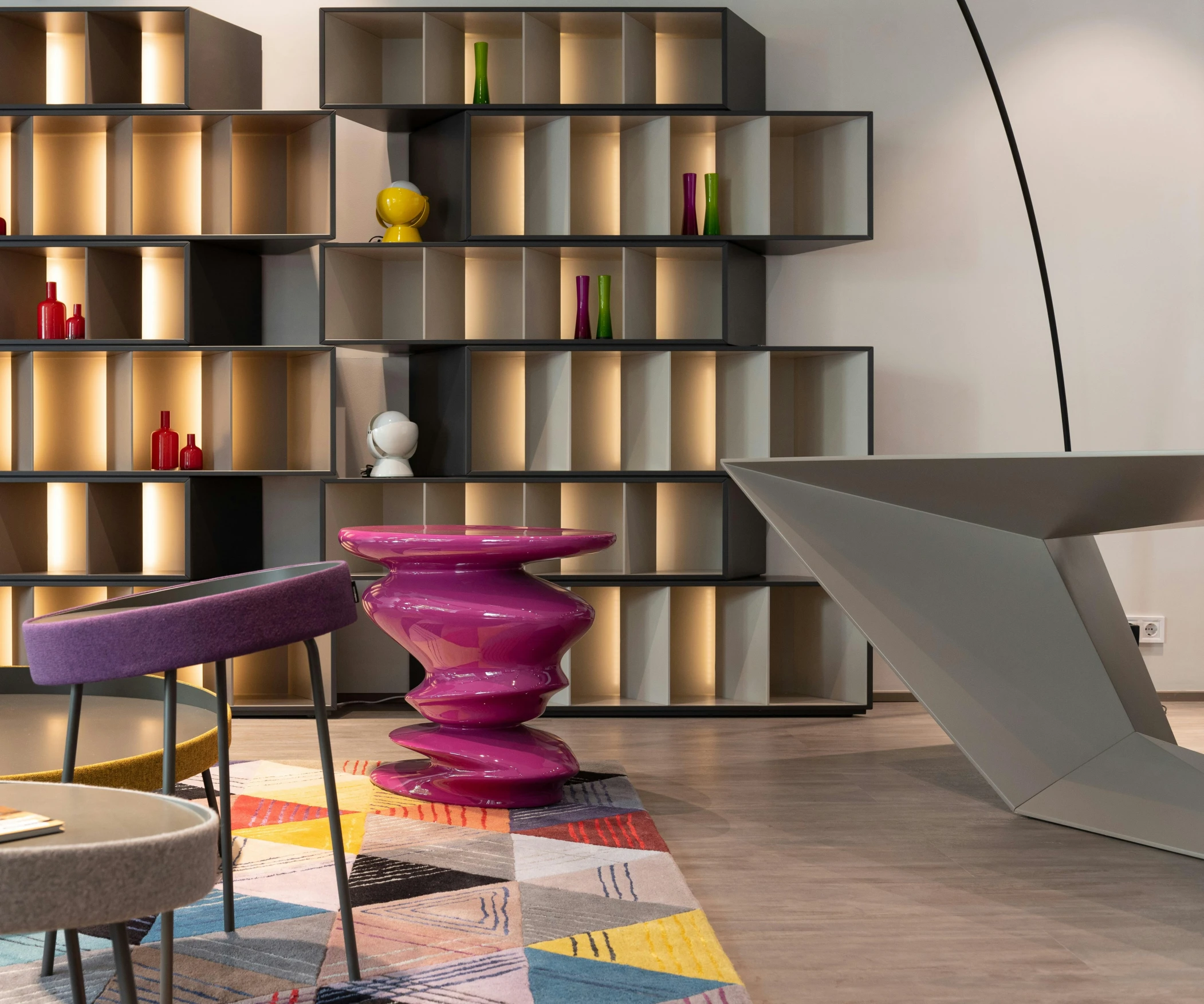 a living room filled with furniture and a colorful rug, a 3D render, inspired by Francesco Furini, infinite library, concrete hitech interior, photo for a store, multicoloured