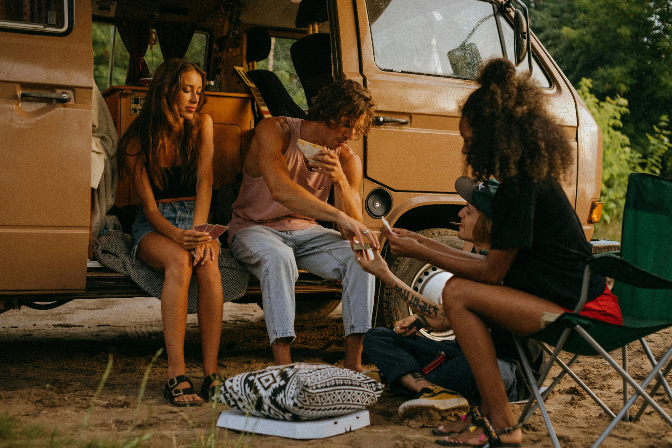 a group of people sitting around a camper van, pexels contest winner, connection rituals, slightly tanned, avatar image, lesbians