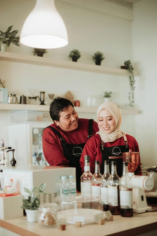 a couple of people that are sitting at a table, inspired by Cafer Bater, pexels contest winner, hurufiyya, at the counter, jakarta, gif, small manufacture