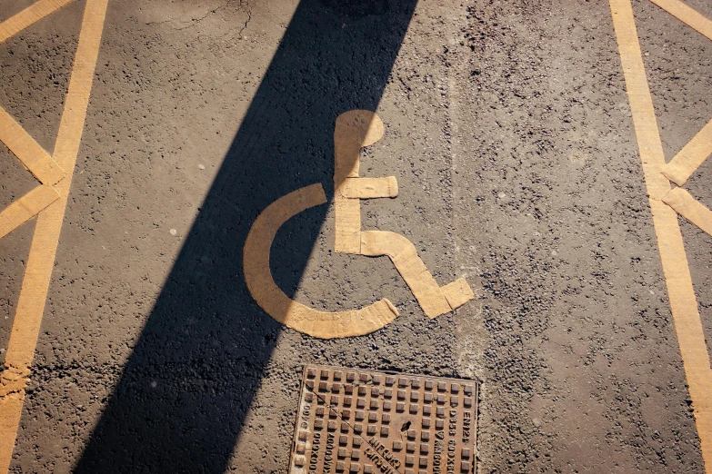 a handicap sign sitting on the side of a road, by Jan Rustem, unsplash, street art, detailed shadows, 15081959 21121991 01012000 4k