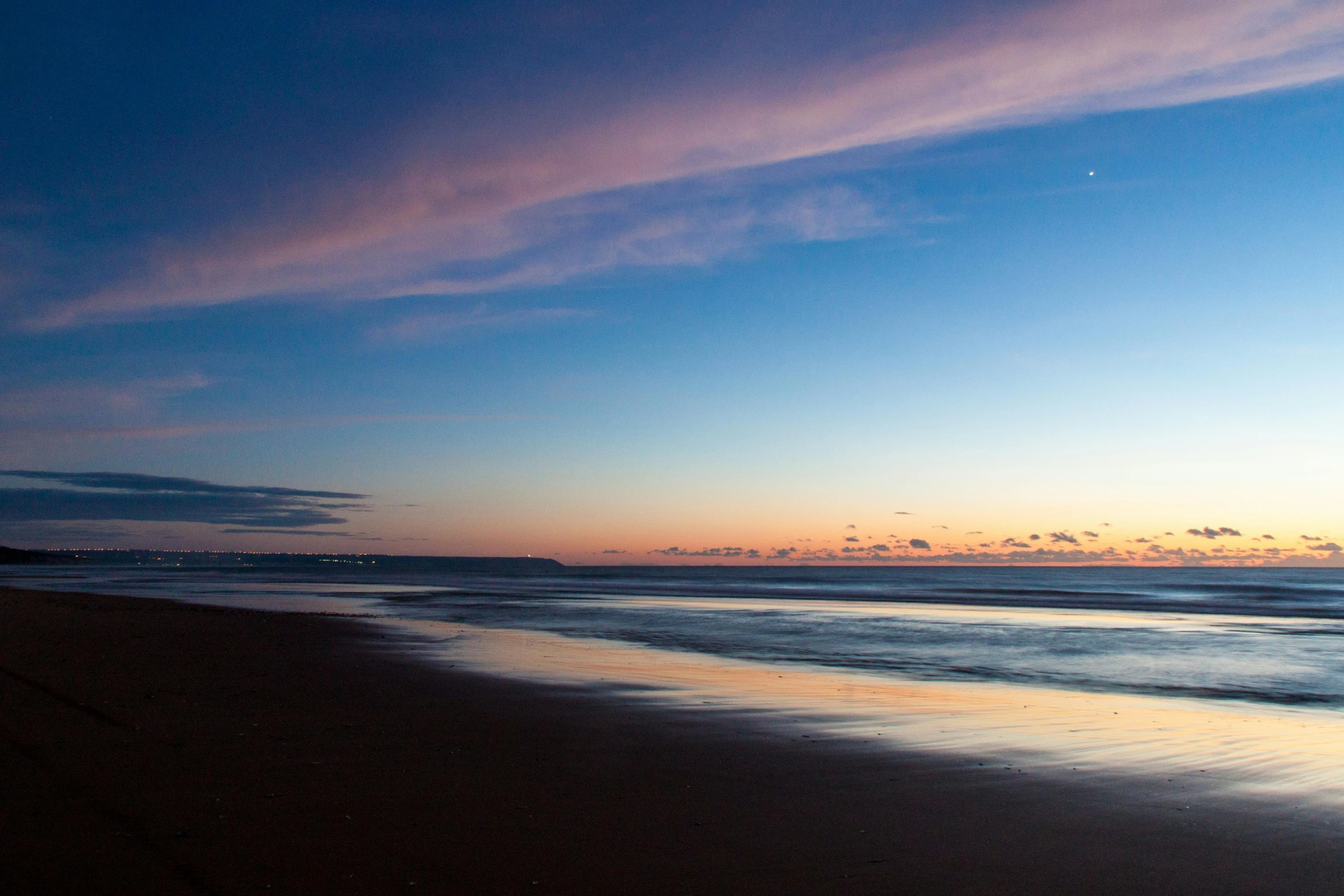 a man flying a kite on top of a sandy beach, by Peter Churcher, unsplash, minimalism, sunset panorama, maryport, refracted moon on the ocean, altostratus clouds