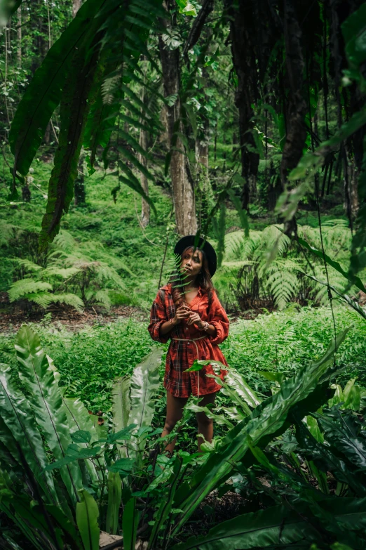 a woman standing in the middle of a lush green forest, sumatraism, portrait of willow smith, sza, ::, conde nast traveler photo