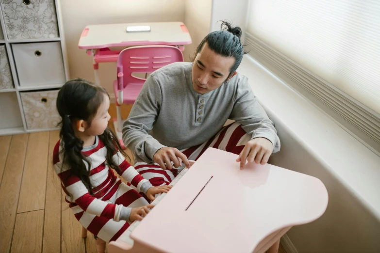 a man and a little girl sitting at a table, pexels contest winner, shin hanga, teaching, wearing pajamas, 15081959 21121991 01012000 4k, lachlan bailey