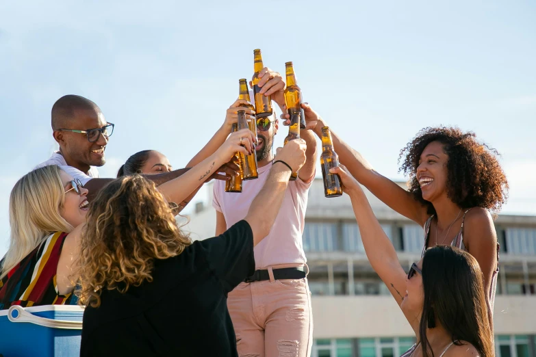 a group of people holding up beer bottles, pexels contest winner, happening, sunny day time, profile image, slightly tanned, alana fletcher