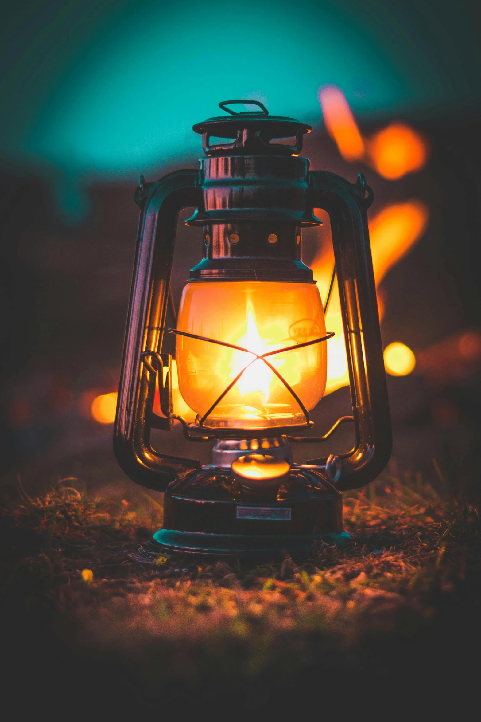 a lantern that is sitting in the grass, pexels contest winner, holding fire and electricity, iconic scene, vibrant setting, front lit