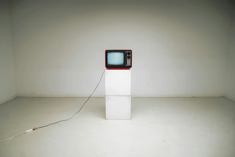 a television sitting on top of a white pedestal, video art, analogue, small, minimalist ) ) ) ) ), cast