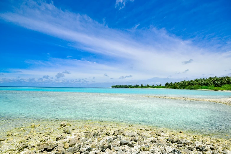 a large body of water next to a sandy beach, coral reefs, big sky, polynesian style, mesmerising