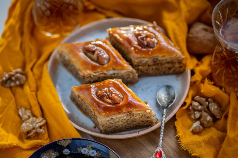 a close up of a plate of food on a table, by Julia Pishtar, hurufiyya, pastries, square, high quality photos, ethnic