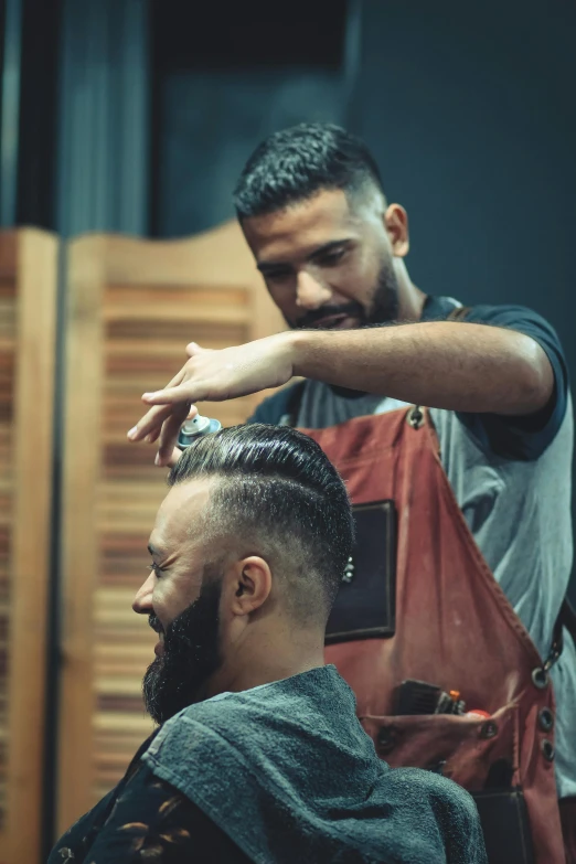 a man cutting another man's hair in a barber shop, trending on pexels, arab man, over his shoulder, thumbnail, colour photograph