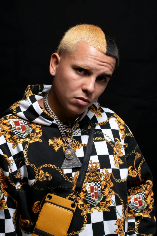 a man with a chain around his neck, an album cover, inspired by Carlos Berlanga, instagram, wearing gold chain, looking serious, no eyebrows, official screenshot