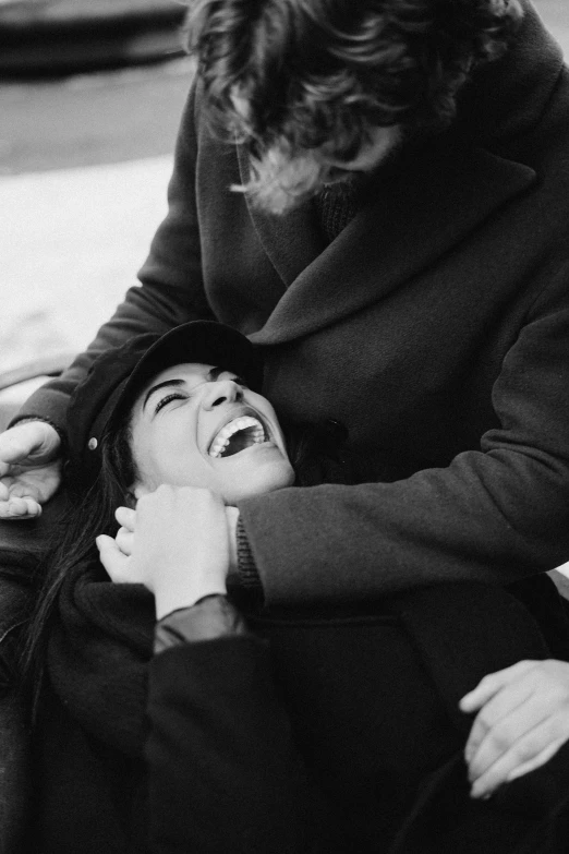 a black and white photo of a woman being comforted by a man, a black and white photo, by Garry Winogrand, pexels, laughing, winter, instagram picture, fighting