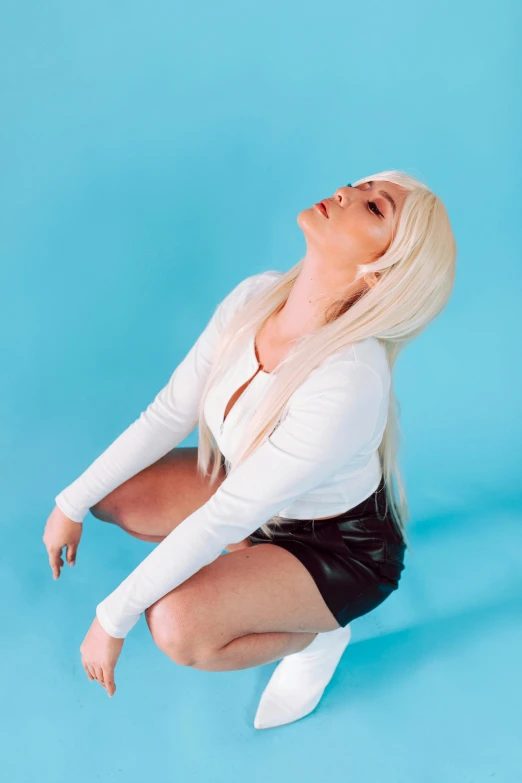 a woman sitting on the ground with her legs crossed, an album cover, inspired by Elsa Bleda, renaissance, tifa lockhart with white hair, nicki minaj curvy, pose 4 of 1 6, profile image