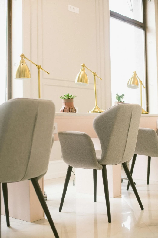 a row of chairs sitting next to each other in a room, profile image, light fixtures, pink and gold, thumbnail