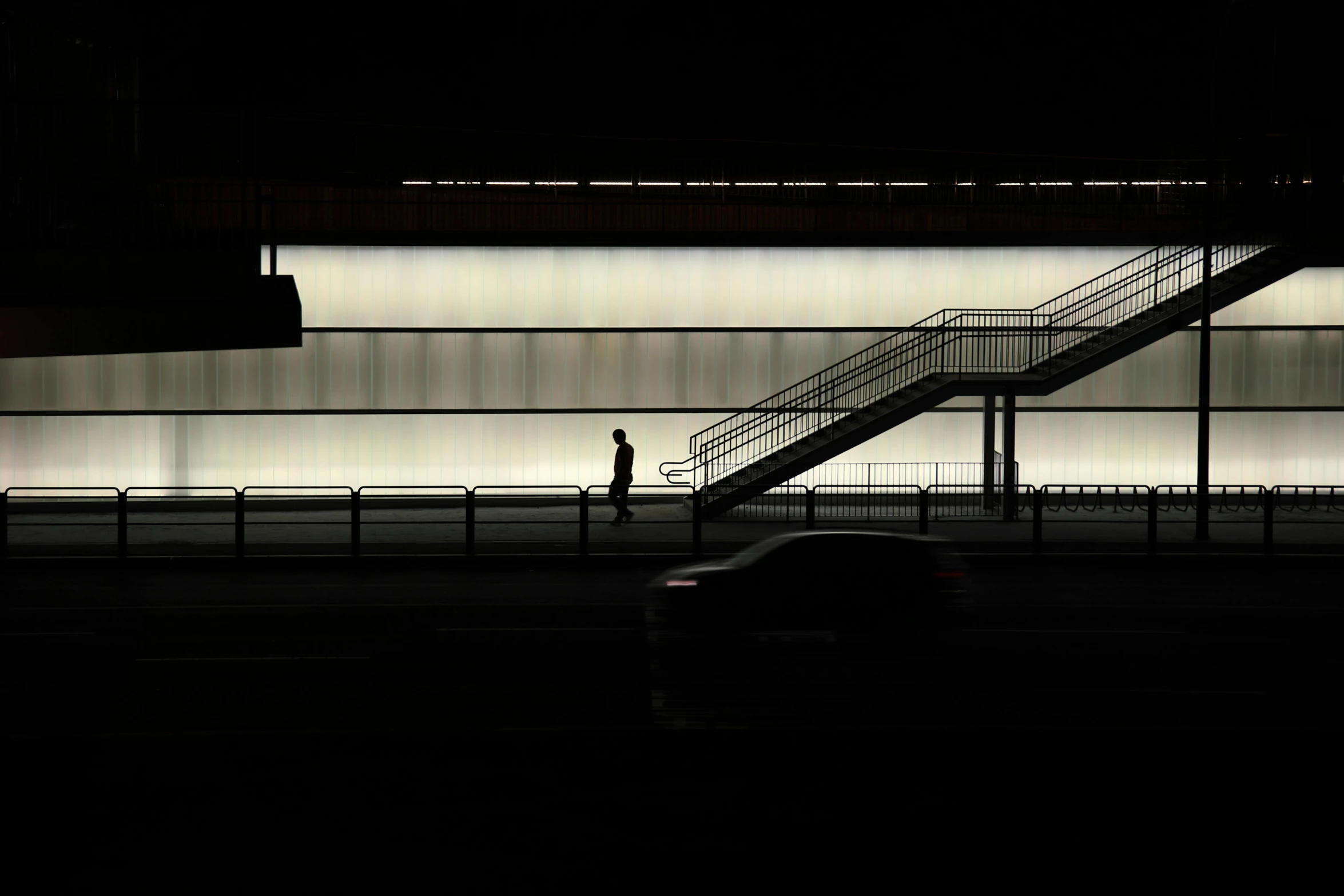 a car parked in front of a building at night, inspired by Andreas Gursky, postminimalism, man walking through city, subway station, morning light, ignant